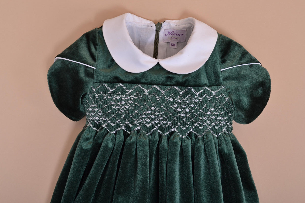 Clémence, Dress with short petal sleeves, peter pan collar, smocked waist, zipped back opening, in Emerald green velvet