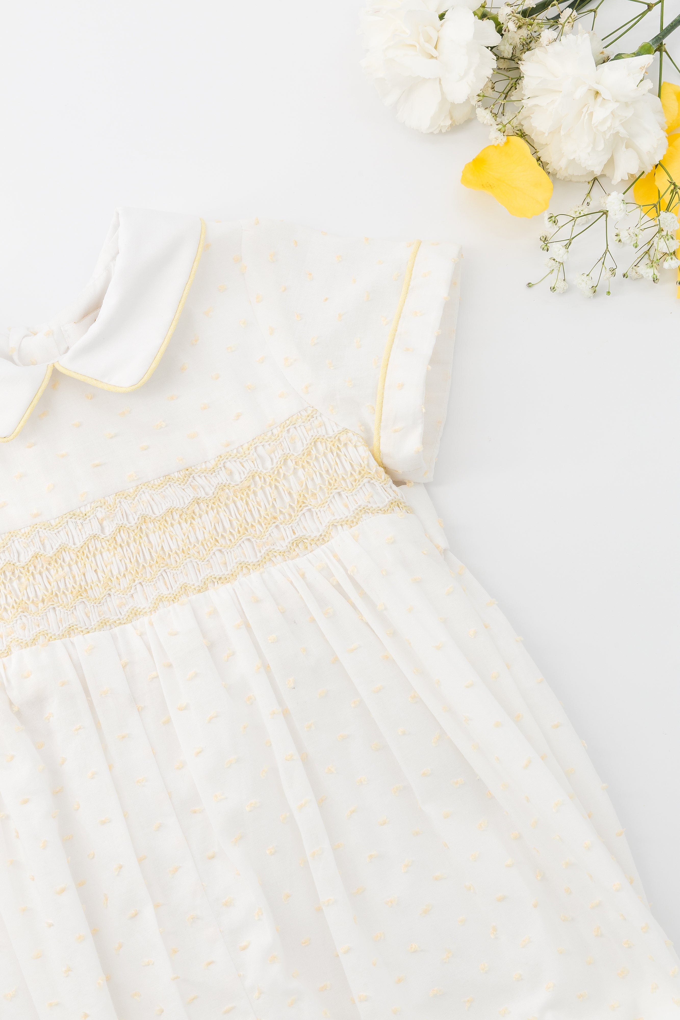 Mathéo, barboteuse smockée pour garçon, en voile blanc avec plumetis jaune
