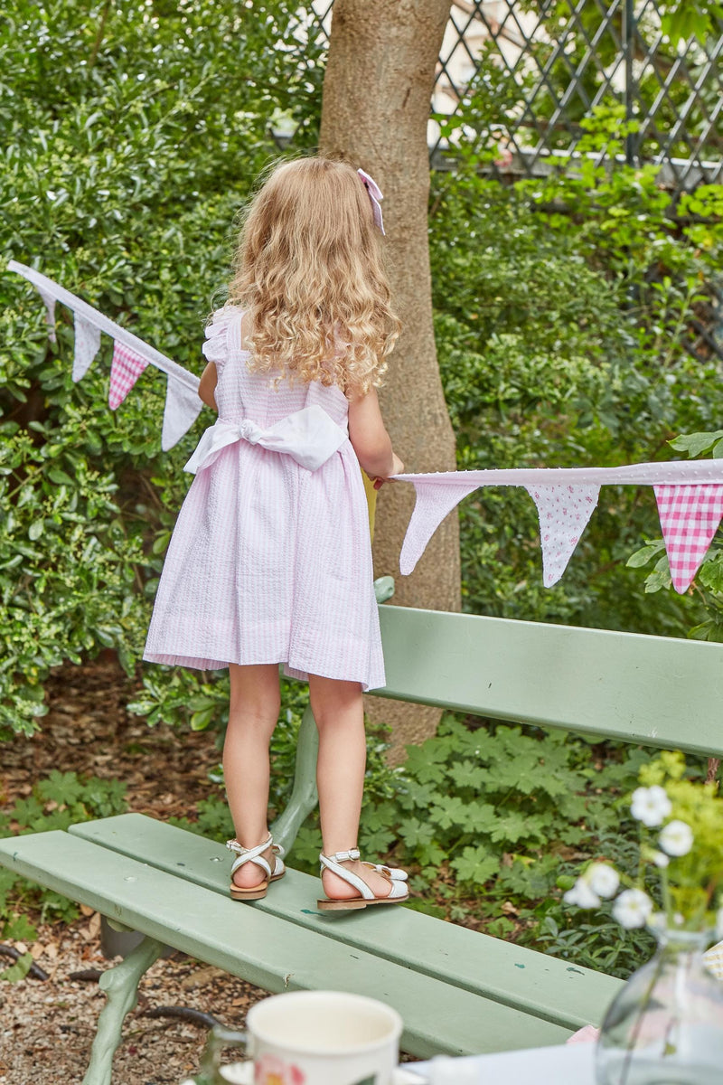 Bégonia, smocked dress with ruffled straps on back, in Pink and white seersucker stripes