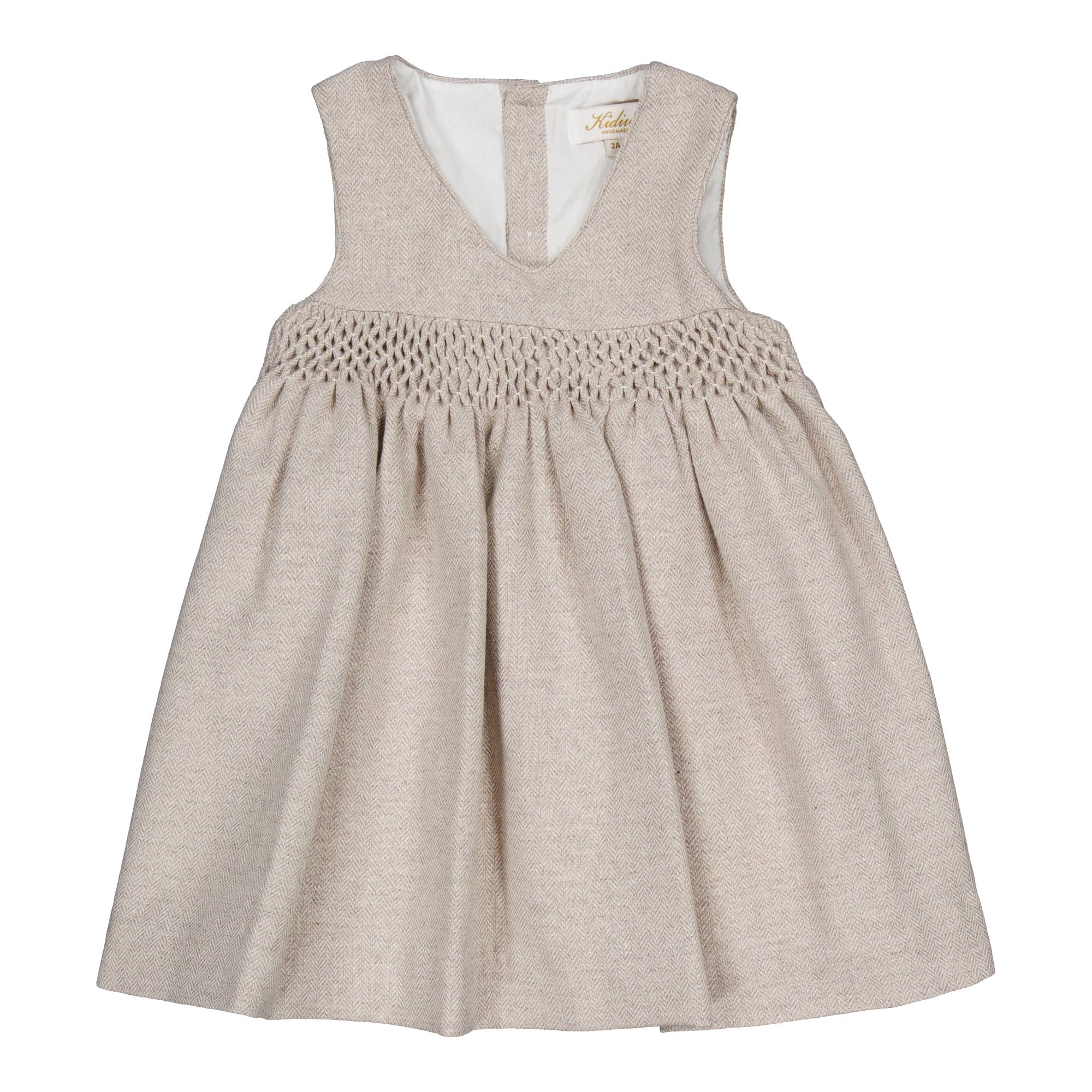Carmelle, robe chasuble smockée en laine beige à chevrons