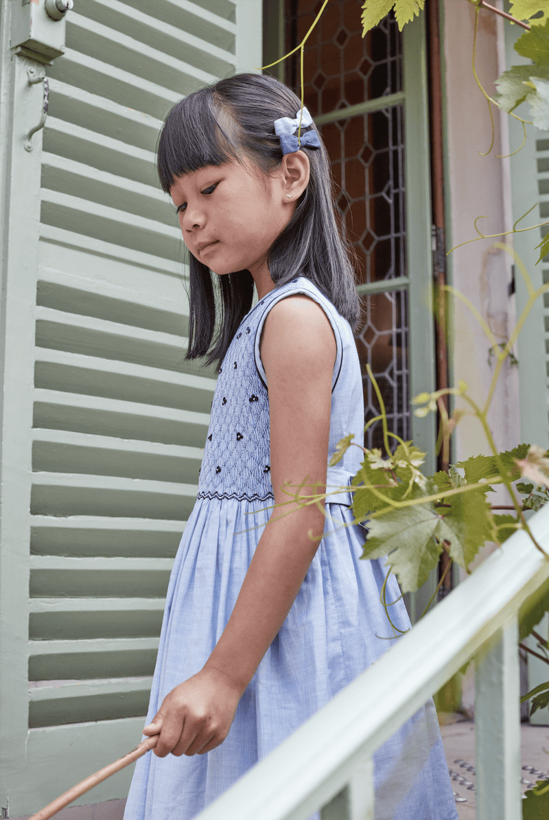 Emma, sleeveless, dress with fully smocked top, inThin blue and whites stripes