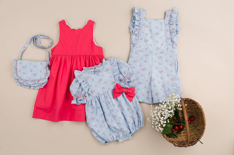 Laéline,  girl dungarees with ruffled smocked straps, in Blue seersucker gingham with bouquet print