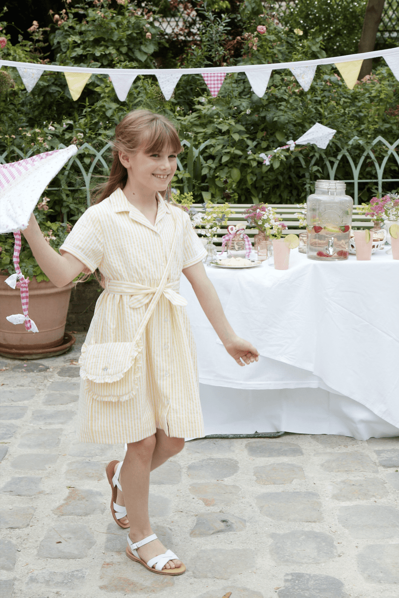 Romane, dress with lapel collar, short sleeves, front opening and tie belt, in Yellow and white seersucker stripes