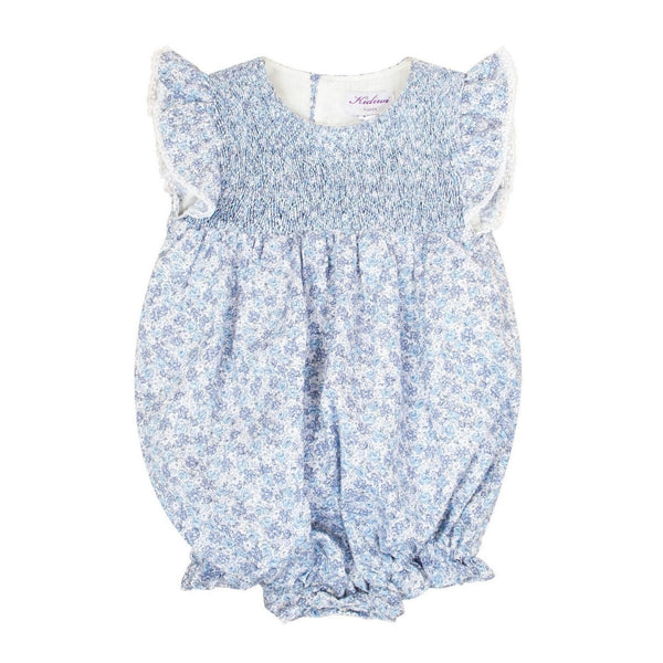 Capucine, Baby girl's romper, round neck, smocked bust, ruffled armhole with lace finish, 3 snaps on the bottom, in small blue flower print