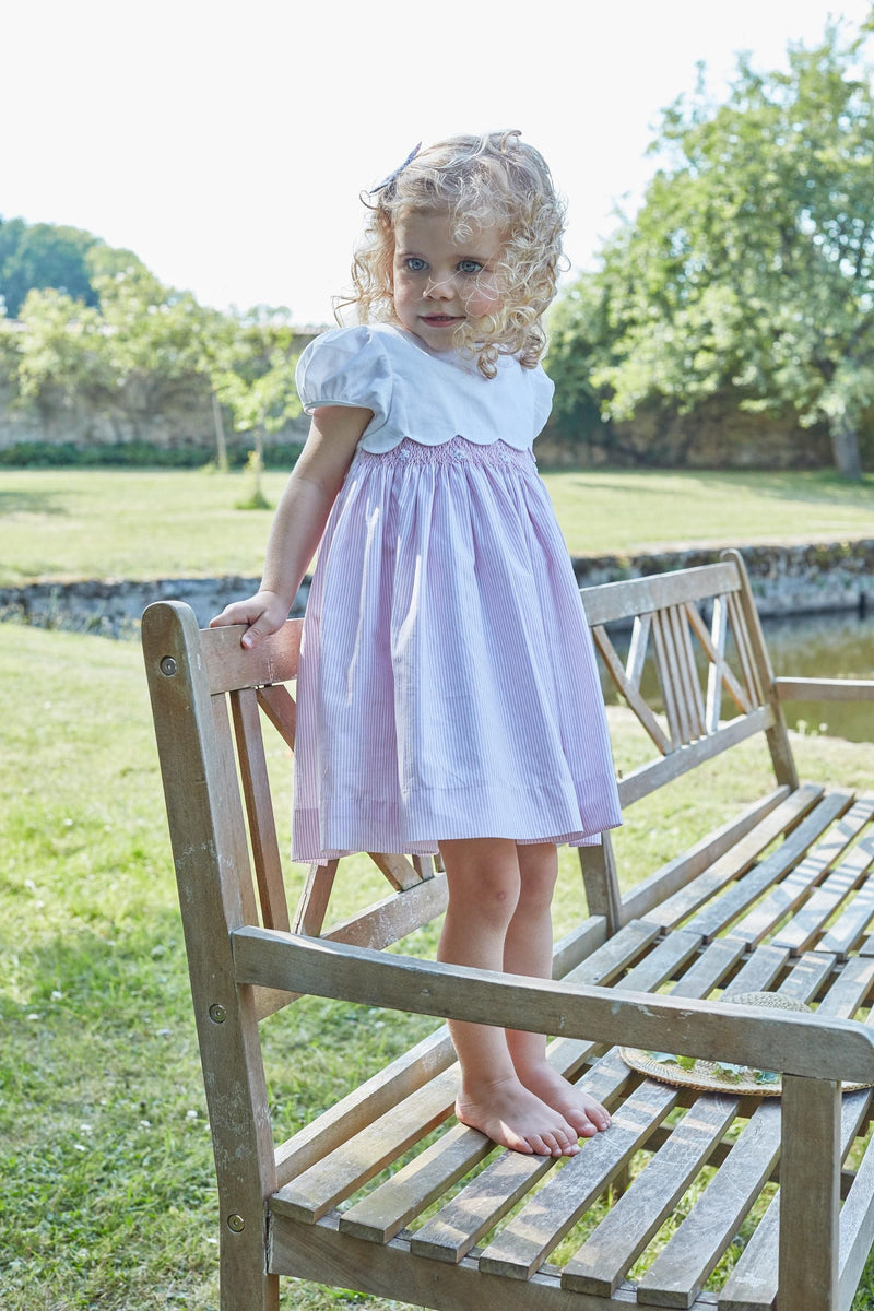 Festony, balloon-sleeved dress top in scalloped white cotton piqué, smocked bottom and embroidered at the waist in 1mm pink and white stripes