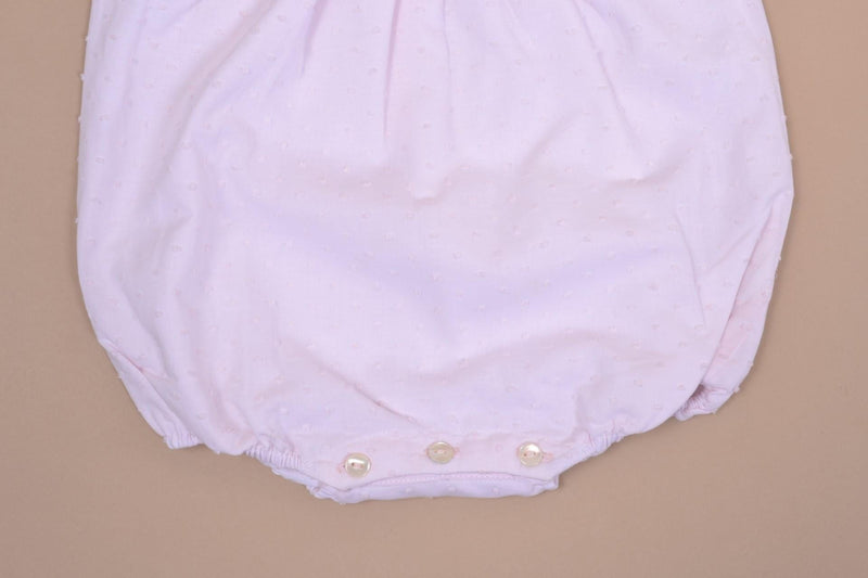 Horsia, Girl's sleeveless romper, embroidered and ruffled pleated bib front and back, opening at the bottom with 3 press studs, in baby pink plumetis
