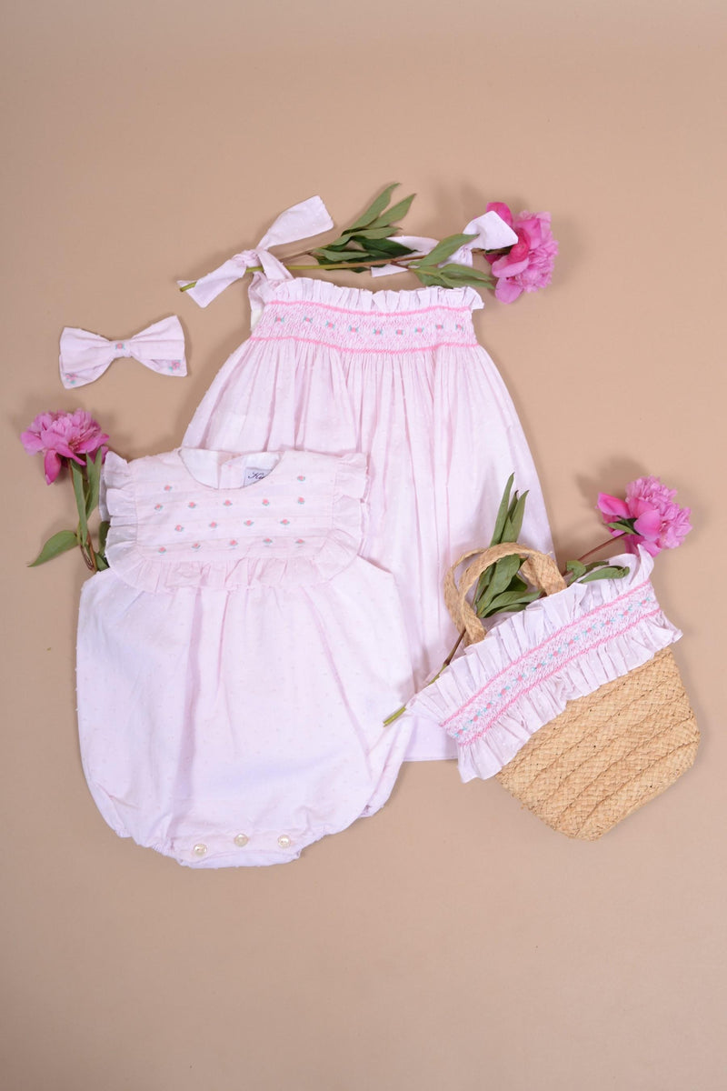 Horsia, Girl's sleeveless romper, embroidered and ruffled pleated bib front and back, opening at the bottom with 3 press studs, in baby pink plumetis